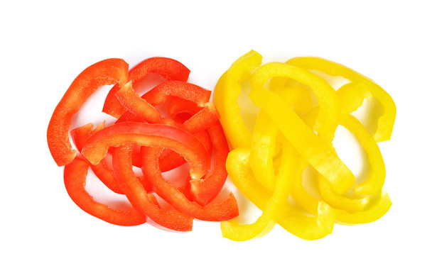 Red and yellow sweet bell pepper slices isolated on white background - Fotó, kép