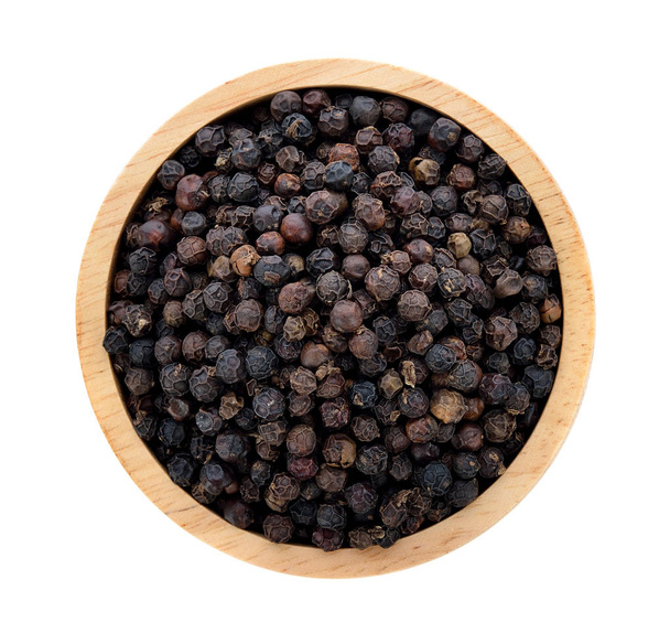 Black pepper in wooden bowl isolated on white background - Photo, Image