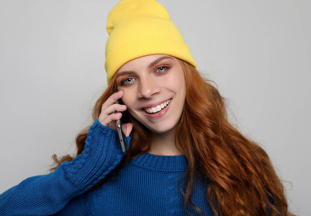 lifestyle, emotional and people concept: Young curly woman with smart phone - Fotó, kép