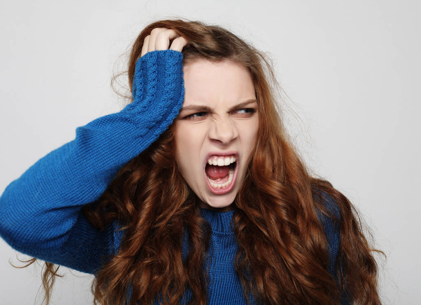 Picture of enraged dissatisfied young female grimacing and making angry gesture. Negative human emotions, feelings and reaction. - Valokuva, kuva