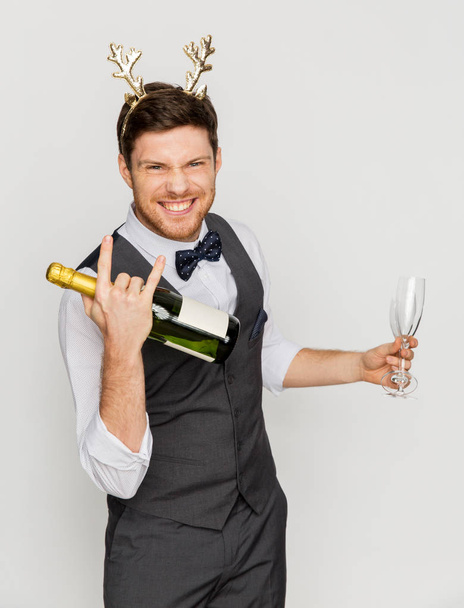 man with bottle of champagne at christmas party - Fotó, kép