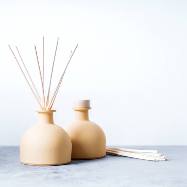 aroma reed fragrance diffusers with rattan sticks on light grey background - Fotó, kép