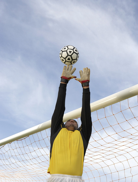 Goalkeeper Jumping To Catch The Ball - Photo, Image