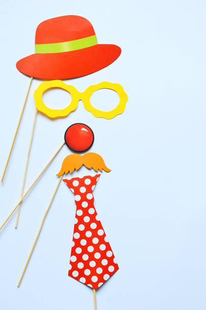 Colorful props for party. Carnival accessories set. Paper glasses, hat, lips, moustaches, tie on wooden sticks - Photo, Image