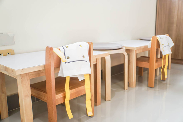 деревянный обеденный стол и стул с милым фартуком
 - Фото, изображение