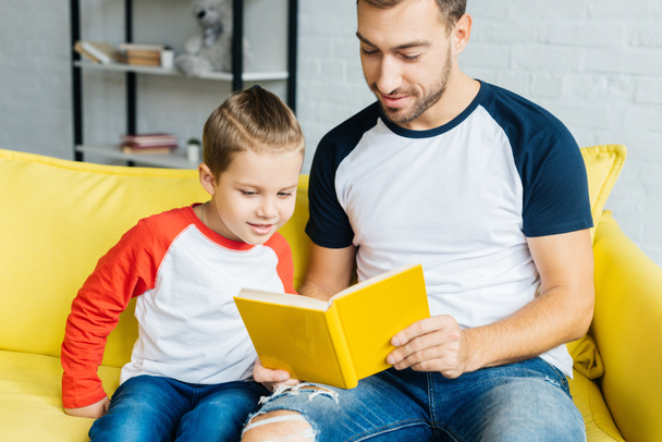 portrait fo father reading book for little son at home - Foto, Imagen