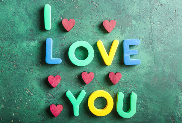 Phrase I LOVE YOU with hearts on color background - Photo, Image