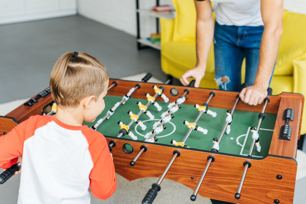 partial view of father and son playing table football together at home - Fotoğraf, Görsel