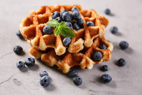 Delicious waffles with blueberries on grey table - Φωτογραφία, εικόνα