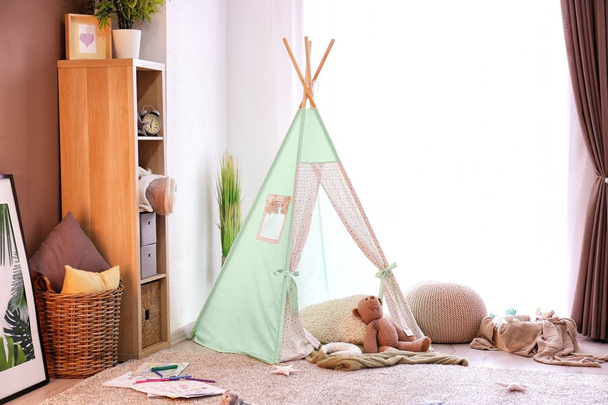 Cozy play tent for kids in interior of room - Фото, зображення