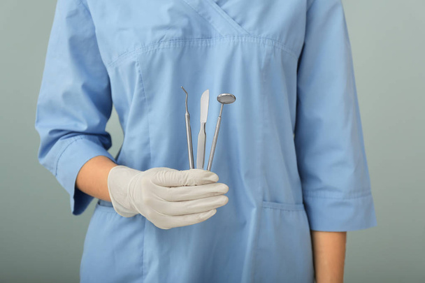Dentist holding stainless instruments, closeup - 写真・画像