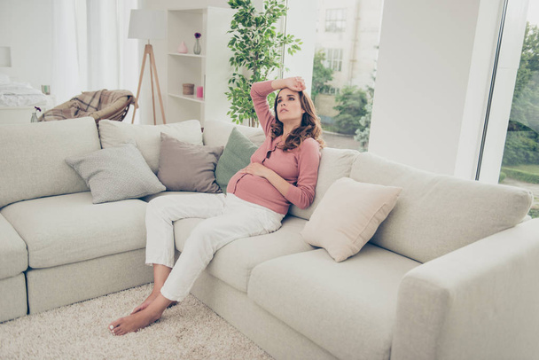 Nice adorable lovely pregnant curly-haired mom in casual wear si - 写真・画像