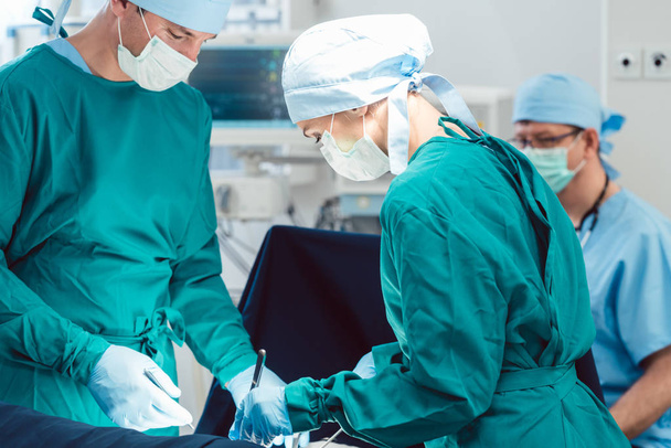 Medici e chirurghi che operano paziente in ospedale
 - Foto, immagini