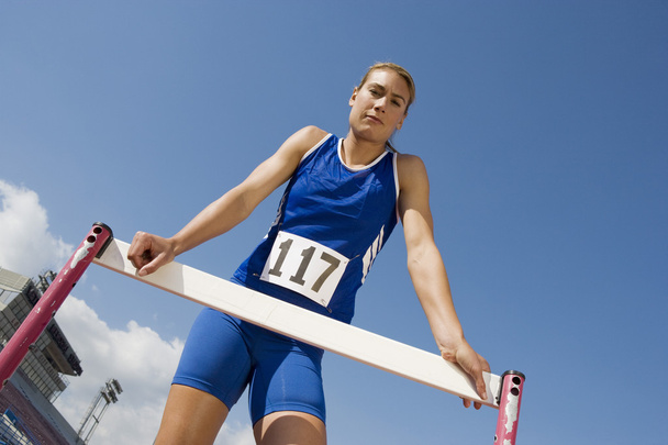 Female Athlete Standing At Hurdle - Foto, Imagem