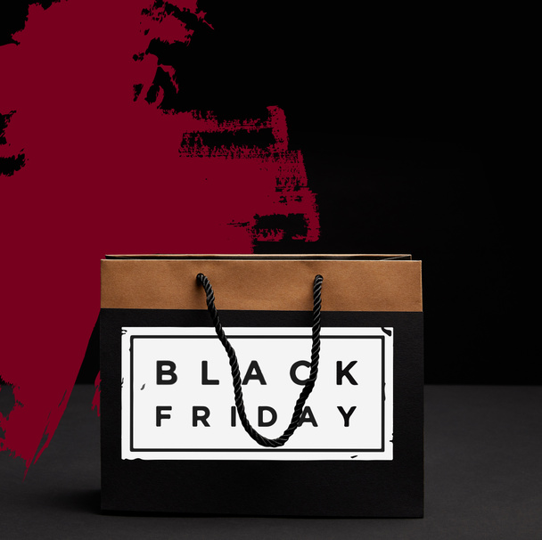close up view of paper shopping bag with black friday sale - Φωτογραφία, εικόνα