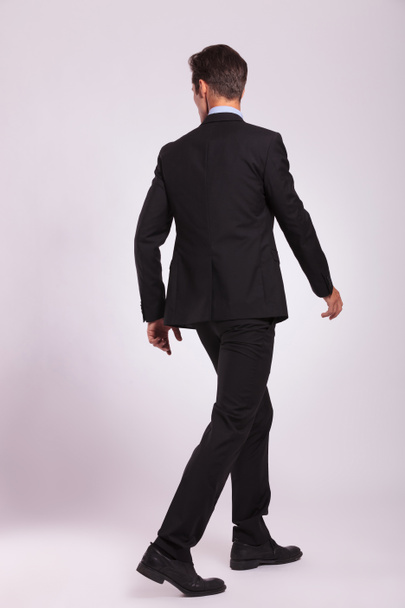 back view of business man walking - Zdjęcie, obraz