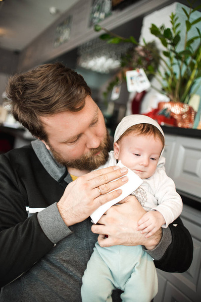bearded father holding little son while sitting in cafe  - 写真・画像