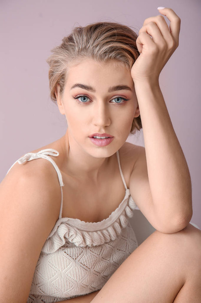 Beautiful young woman with nude makeup on color background - Zdjęcie, obraz