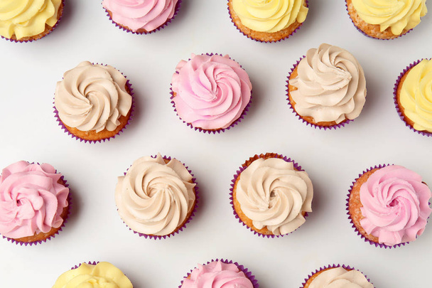 Delicious cupcakes on white background, flat lay - Photo, Image