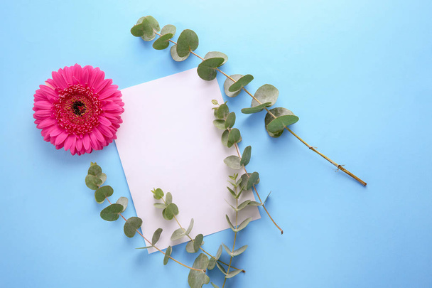 Beautiful flower, branches and blank card on color background - Photo, Image