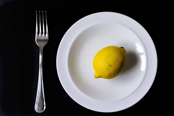 A conceptual image of minimal food, with a single item on a dish - Photo, Image