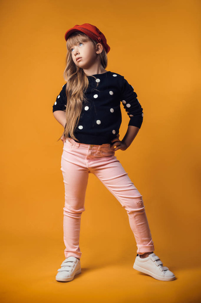 child in the Studio posing in fashionable clothes in red color heart - Foto, imagen
