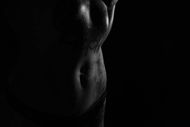 Monochrome bodyscapes of a fit tattooed woman - Photo, Image