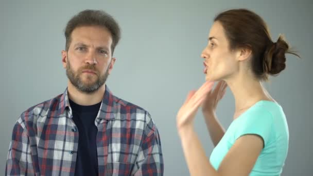 Man showing stop sign to annoyed wife who constantly screaming and complaining - Filmmaterial, Video