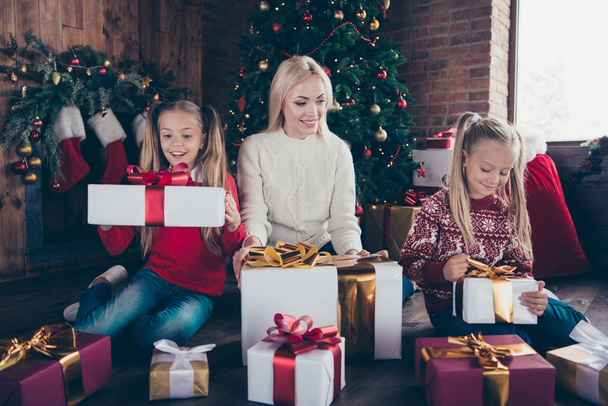 Holly jolly x mass winter! Full legs body size glad cheerful charming kind stylish blonde mom and two small pre-teen offspring in soft sweater sit on floor in comfort cozy house open big package - Foto, Bild