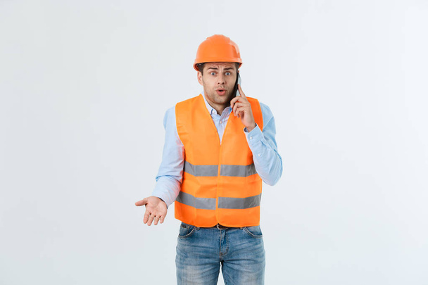 Young man wearing architect outfit and helmet with angry face, negative dislike emotion. Angry and rejection concept - Photo, Image