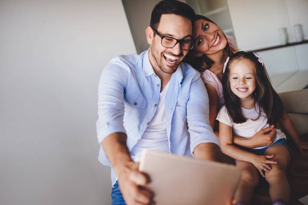 Happy family having fun taking selfie in their house - Valokuva, kuva