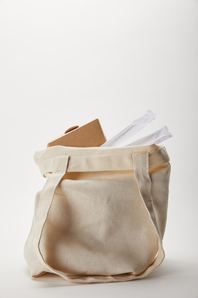 close up view of cotton bag with chopsticks and noodle box on white - Valokuva, kuva