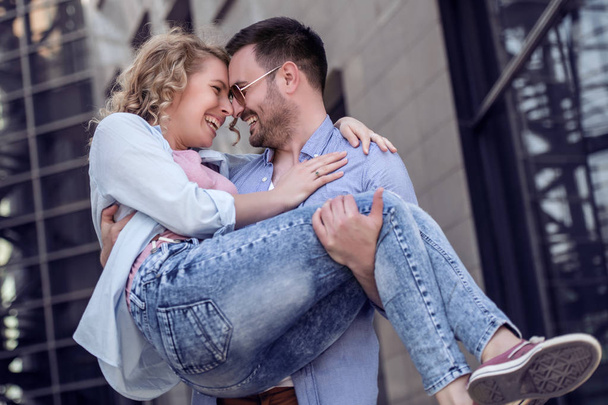 Young happy couple spending good time on city street - Foto, imagen