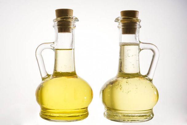 oil in two jars, isolated on white background.  - Valokuva, kuva