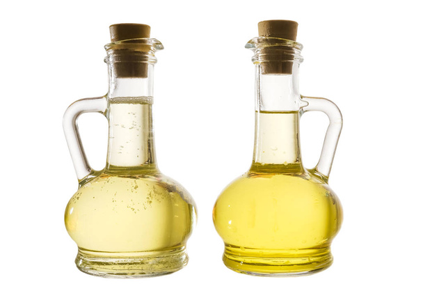 oil in two jars, isolated on white background.  - Foto, afbeelding