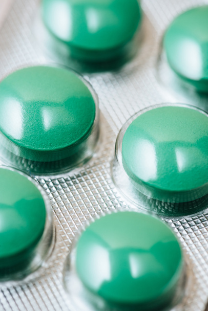 close-up shot of blister with green pills - Fotoğraf, Görsel