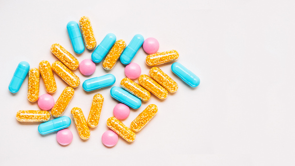 vista superior de diferentes pílulas coloridas na superfície branca
 - Foto, Imagem