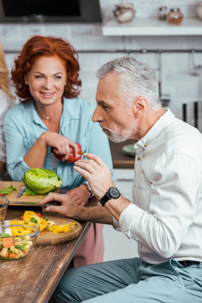 mature couple having salad for dinner at home - Фото, изображение