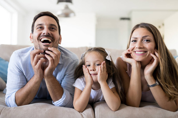 Happy family having fun time watchin tv at home - Zdjęcie, obraz