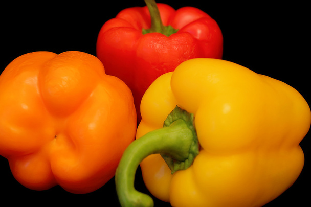 Raw peppers on black background - Photo, Image
