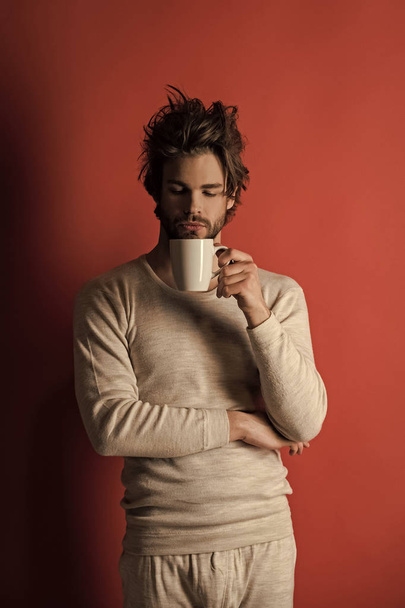 sleepy man with disheveled hair drink coffee in morning, cold - Fotoğraf, Görsel