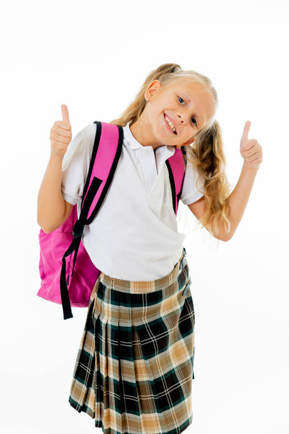 Pretty cute blonde hair girl with a pink schoolbag looking at camera showing thumbs up gesture happy to go to school isolated on white background in back to school and children education concept - Фото, изображение