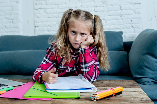 Beautiful cute blonde girl feeling sad and a overwhelmed trying to study at home. Learning difficulties exams homework and school education concept. - Фото, зображення