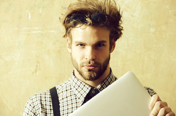 Handsome man in nerd glasses on head holding laptop - Foto, Imagem