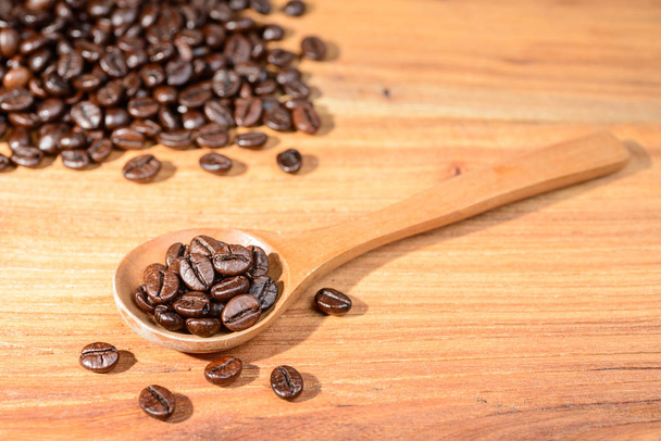 coffee beans in the wooden spoon - Fotó, kép