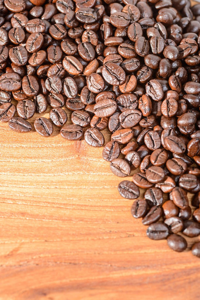 roasted coffee beans on the wooden board - Fotó, kép
