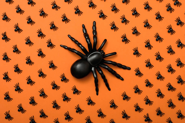 Halloween background, black spiders on the orange background - Foto, imagen