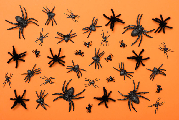 Halloween background, black spiders on the orange background - Foto, imagen