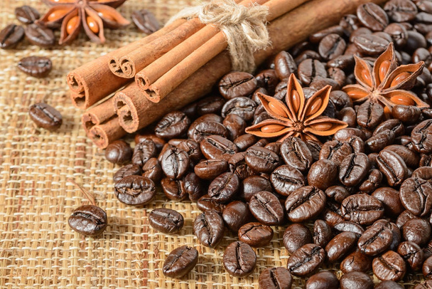 coffee beans and cinnamon sticks - Fotó, kép