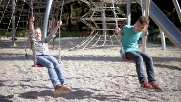 Children on swings at playground - Záběry, video
